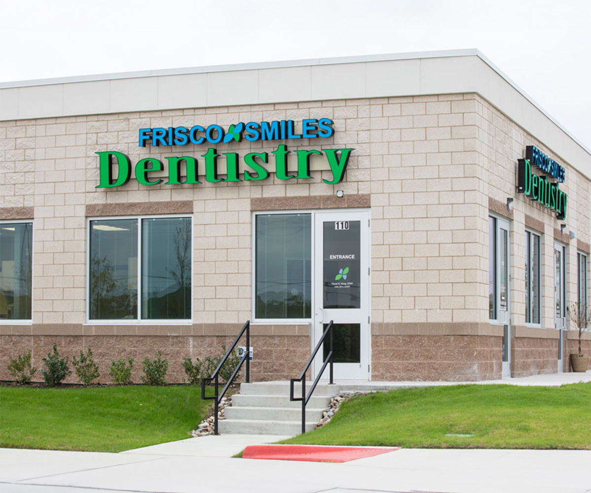 The image shows a dental clinic named Fresco Smiles Dentistry with a sign on its exterior.